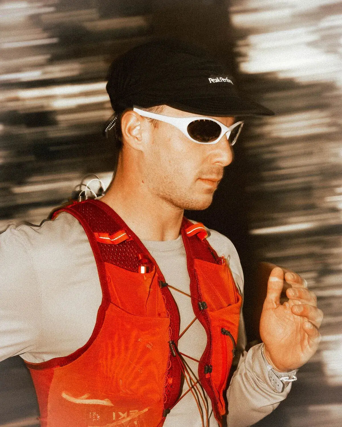 Trail runner in a red vest wearing the frame