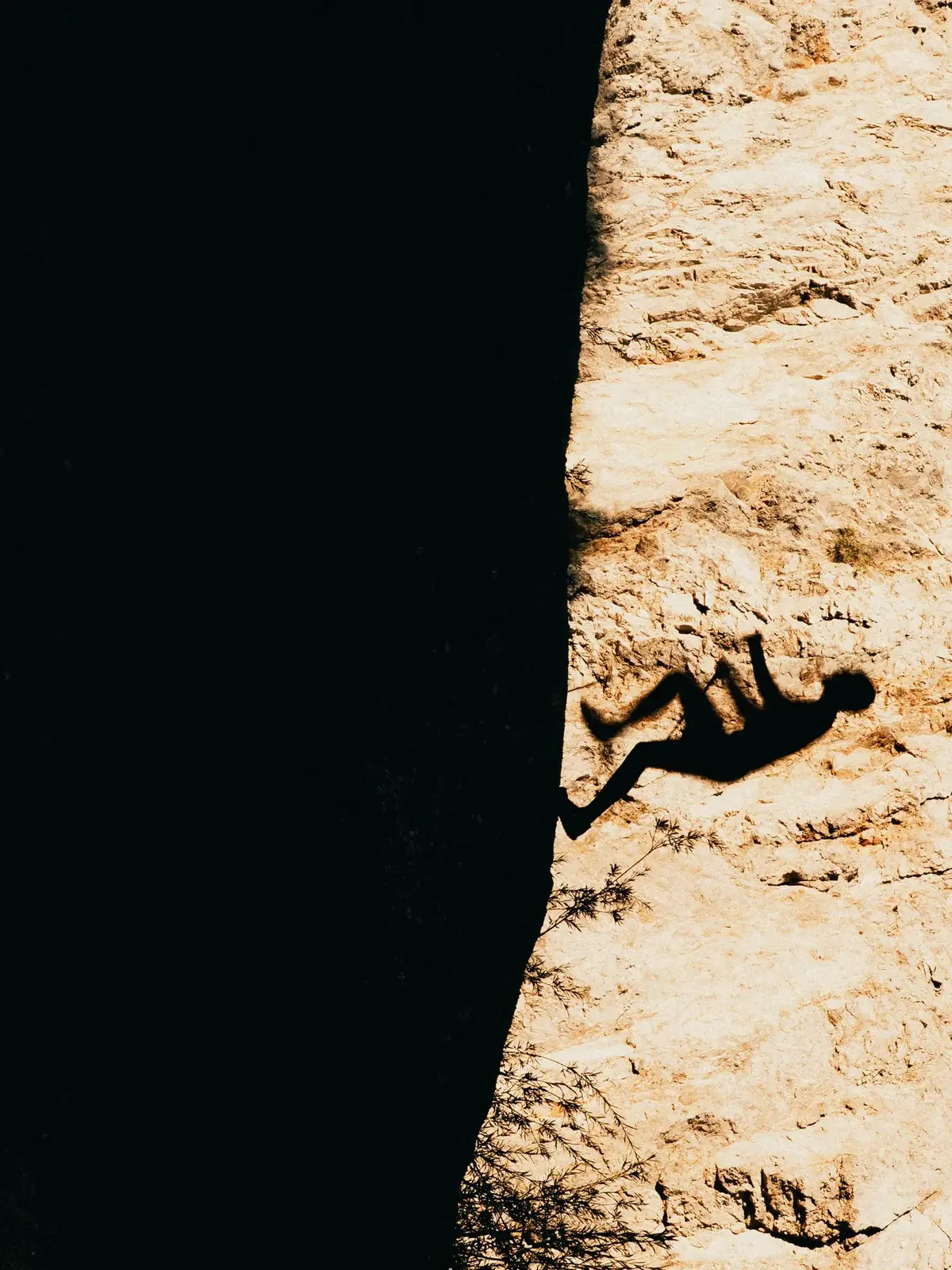 Climber silhouetted on a rock face